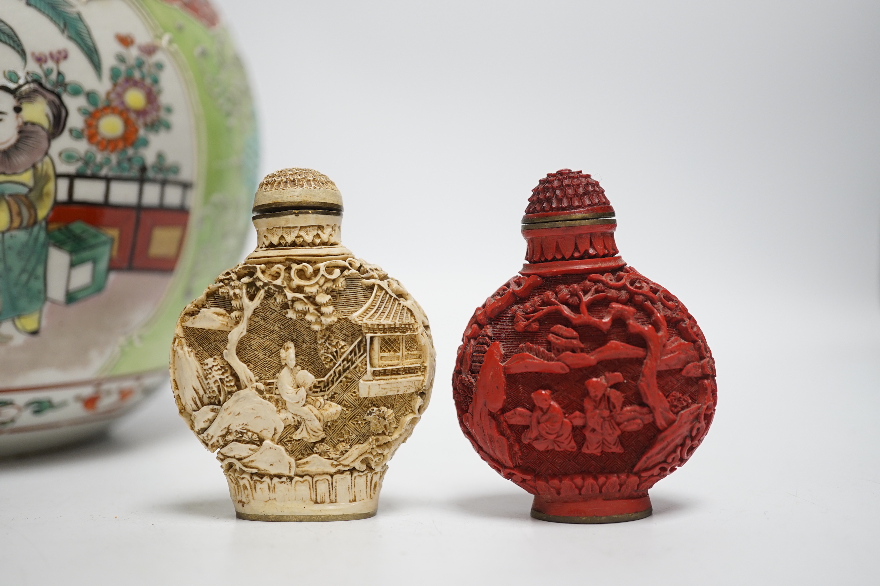 An early 20th century Japanese famille rose snuff bottle together with three others and a lidded jar